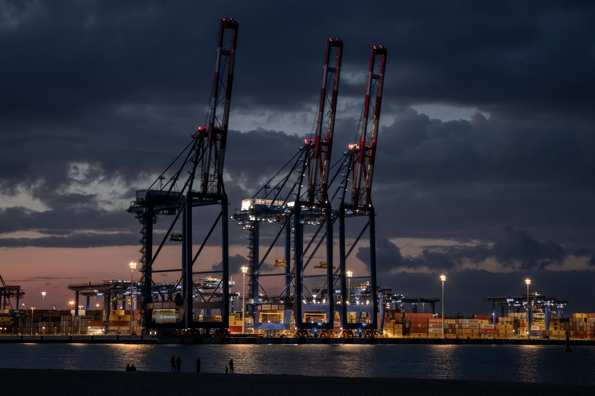 Port cranes over a container terminal at dusk